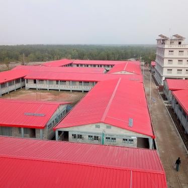 A man walks past buildings on Bhasan Char, or floating island, in the Bay of Bengal, Bangladesh on December 19, 2019.