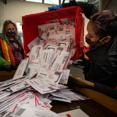 Election workers empty ballots at the Multnomah County Elections Division in Portland, Oregon, November 3, 2020. 