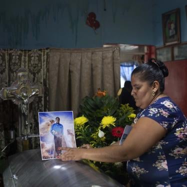 A woman places a photo of slain journalist Julio Valdivia on his casket during a wake inside his home in Tezonapa, Mexico, on September 10, 2020.