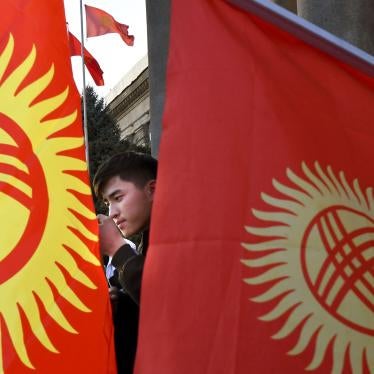 A protester listens to a speaker during a rally in front of the government building in Bishkek, Kyrgyzstan, Wednesday, October 14, 2020. 
