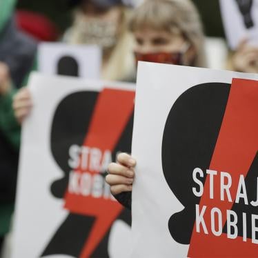 Women's rights activists, holding posters of the Women's Strike action, protest further tightening of Poland's restrictive abortion law in front of the parliament building in Warsaw, Poland, on Tuesday, October 27, 2020. 