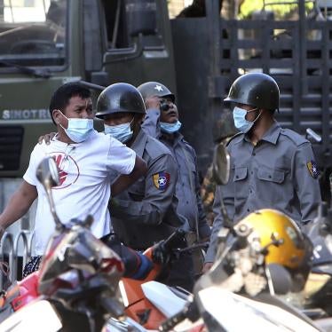 A man is held by police during a crackdown on anti-coup protesters holding a rally in front of the Myanmar Economic Bank in Mandalay, Myanmar on February 15, 2021.