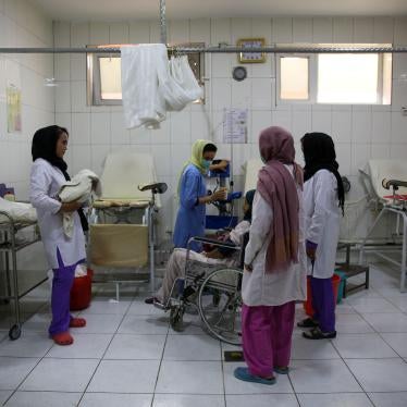 Midwives care for a mother who has just given birth in a hospital room