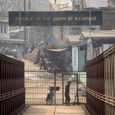 A Myanmarese man looks towards the Indian side at the India-Myanmar border in Mizoram, India, Saturday, March 20, 2021. 