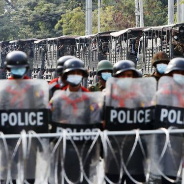 Soldiers and police stand guard behind a road barricade in Mandalay, Myanmar, February 19, 2021.