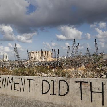 In this Aug. 9, 2020 file photo, political graffiti is visible in front of the scene of the August 4 explosion that hit the seaport of Beirut, Lebanon
