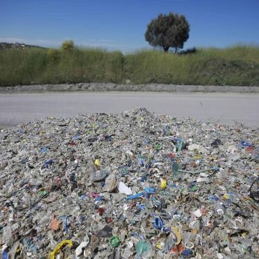 A pile of garbage and waste next to a road