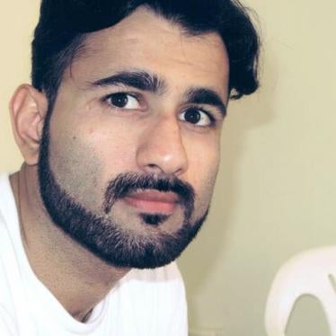 Photo of a man with black hair and a bear