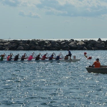 Kaola Baird racing with teammates at the Dragon Boat Race Festival
