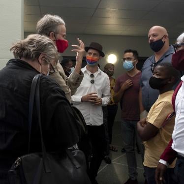 A group of men and women wearing face masks