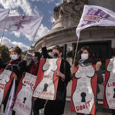 Women at a protest holding placards and flags