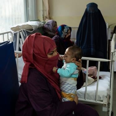 A woman holds her baby in a hospital room