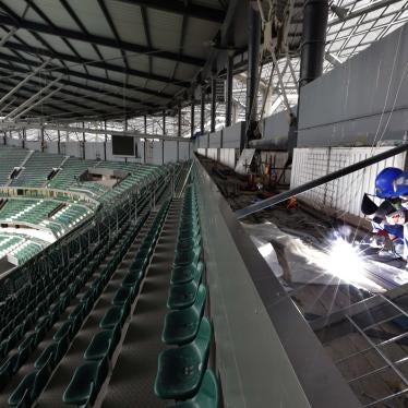 Workers in the seats of a stadium 