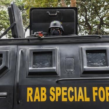 A Bangladeshi RAB (Rapid Action Battalion) member stands alert inside a truck at the Central Shaheed Minar in Dhaka, Bangladesh, February 20, 2021.