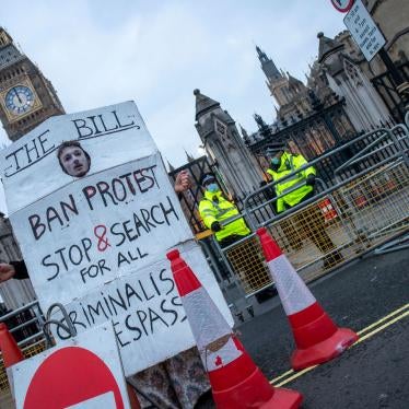 A protestor holds a sign outside the Houses of Parliament in London