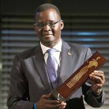 Nicholas Opiyo, human rights lawyer and founder of Chapter Four Uganda, holds the German Africa Award