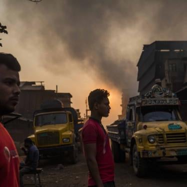 Two men stand in a smog-filled street