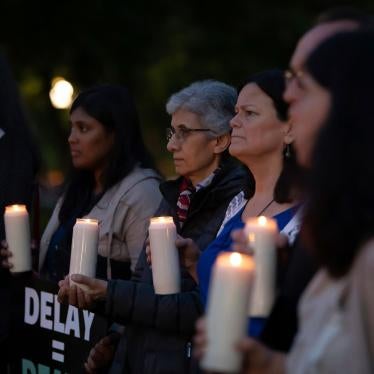 Activists hold a candlelight vigil