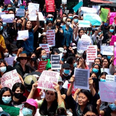 People chant slogans and display placards during a protest