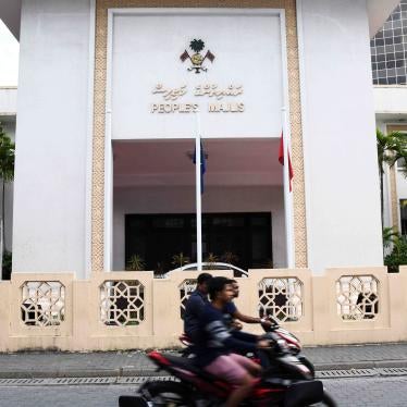 Motorists ride past the People's Majlis