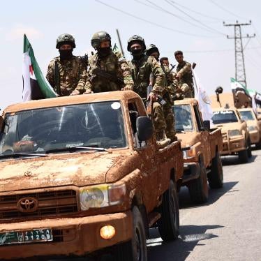 Fighters of the Turkish-backed Syrian National Army take part in a military parade in the countryside of Aleppo Governorate on June 9, 2022, as part of the forces' preparations for military actions on the areas controlled by the Syrian Democratic Forces.