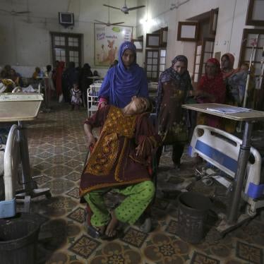 A pregnant woman being pushed in a wheelchair
