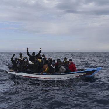 Migrants aboard on a wooden boat in the Mediterranean Sea.