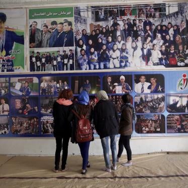 Jiu Jitsu club members look at a wall with posters at their club ahead of a training session in Kabul, Afghanistan, Saturday, Feb. 15, 2020.