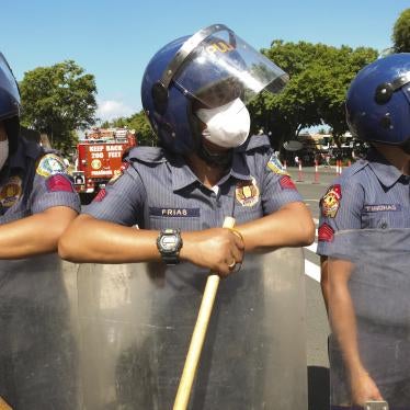 Philippine police officers with batons during a demonstration by youth group activists in Manilla,