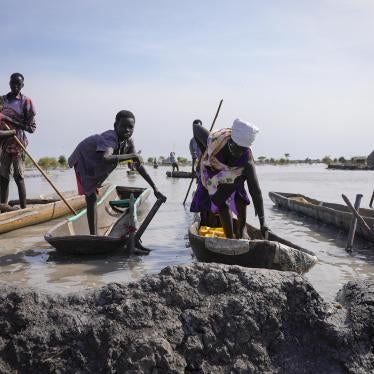 Residents park their dugout canoes next to a mud dyke they built to try and prevent flooding
