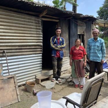 A family stands in front of their home