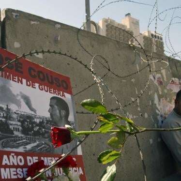 A memorial poster for Jose Couso, a Spanish television cameraman killed by a U.S. tank shell which hit Baghdad's Palestine hotel, on a barricade outside the building in 2004.
