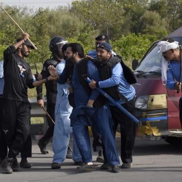 Police detain a supporter of Pakistan's former Prime Minister Imran Khan during clashes, in Islamabad, Pakistan.