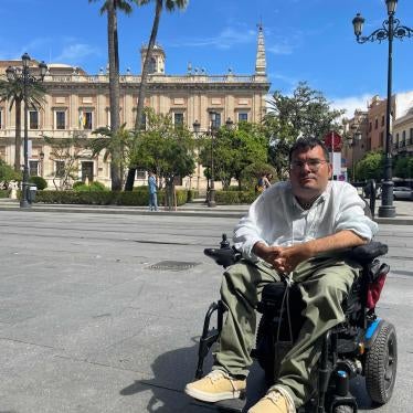 Carlos Reina Rosales, 35, sits in his electric wheelchair, in front of a museum in central Seville (Andalusia, Spain). 