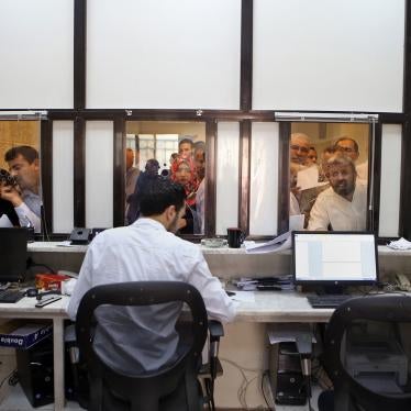 Syrians line up to apply for passports inside of the Embassy of Syria in Amman, Jordan, September 15, 2015.