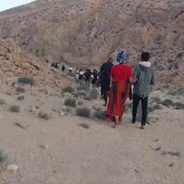 Black African migrants and asylum seekers walk in the desert near the Tunisia-Algeria border between July 5 and 7, 2023 after collective expulsion or forcible transfer there from Sfax, Tunisia, by Tunisian security forces. © 2023 Private