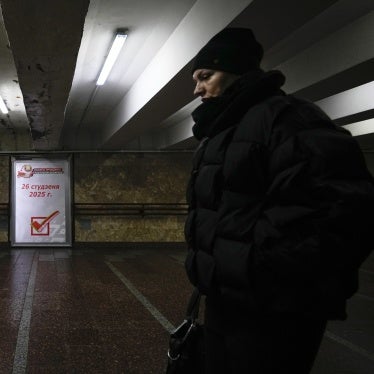 A woman walks past an election poster