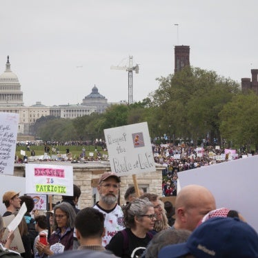 People protest the Trump administration's massive employment and funding cuts in Washington, DC, April 5, 2025.