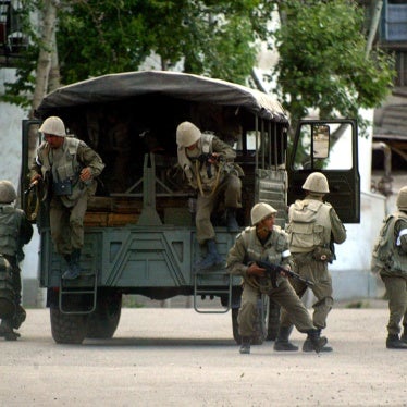 Soldiers jump out of a truck in the city of Andijan, Uzbekistan on May 13, 2005, where that day security forces opened fire on overwhelmingly peaceful protestors, killing hundreds and wounding more.