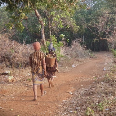 Two people walking down a rural road