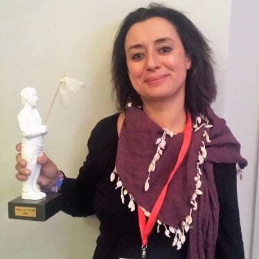  Ibtissame Lachgar holding her One Law For All award at the Secular Conference.