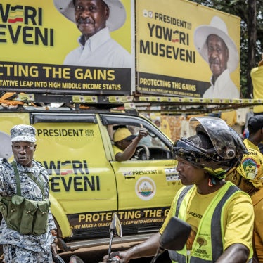 A member of the Ugandan police force gives instructions to supporters of Uganda's incumbent president and National Resistance Movement (NRM) presidential candidate Yoweri Museveni entering the rally grounds ahead of the party's closing campaign rally ahead of the 2026 Ugandan general elections, in Kampala on January 13, 2026.