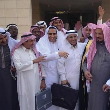 Saudi human rights activists gather outside the Criminal Court of Riyadh following a hearing in the trial of fellow activists Abdullah al-Hamid and Mohammed al-Qahtani. 