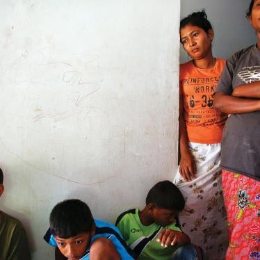 Rohingya women and children who arrived by boat from Burma pass the time at a closed shelter in Phang Nga, Thailand, in October 2013