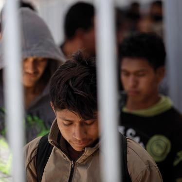 Men recently deoported from the United States wait in line to be registered with Mexican authorities at the border in Nogales, Mexico.