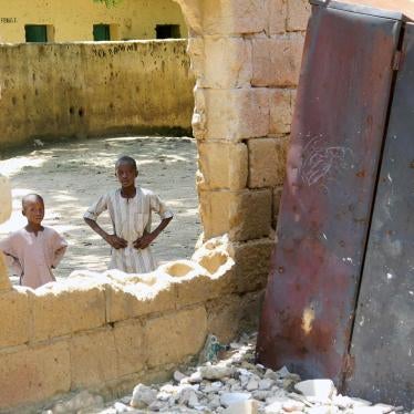 Children look through a destroyed classroom window at Yerwa Primary School, Maiduguri, Borno state, damaged by Boko Haram during attacks in 2010 and 2013. The school, established in 1915, was the first primary school in northeast Nigeria. © 2015 Bede Shep
