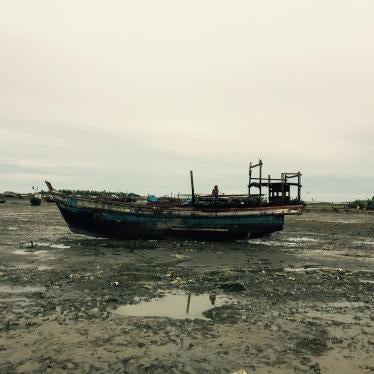 A Rohingya girl sits atop a fishing boat on the outskirts of an IDP camp in Sittwe, Arakan State, Burma, September 2015. 