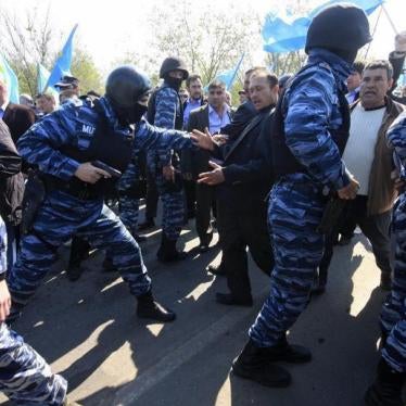 Russian security forces attempt to block Crimean Tatars trying to cross a checkpoint connecting Crimea to the rest of Ukraine, to attend a meeting. 