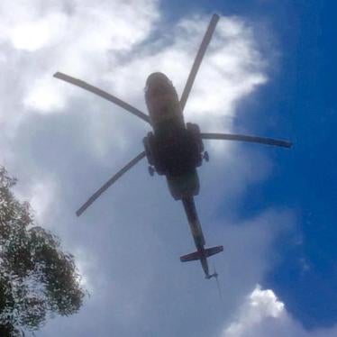 Government helicopter gunship flying low over IDP site at the UN base in Thongpiny, Juba, South Sudan. 