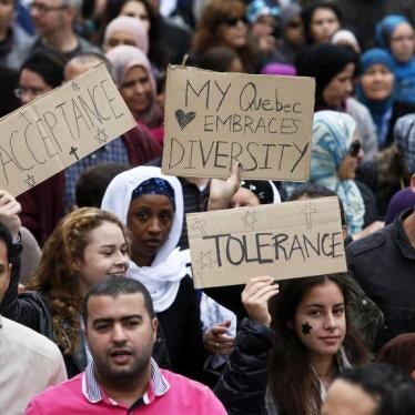 Demonstrators hold signs as they protest against Quebec's proposed Charter of Values in Montreal, September 14, 2013.